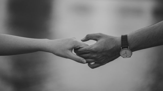 Man and woman holding hands in a black and white photo